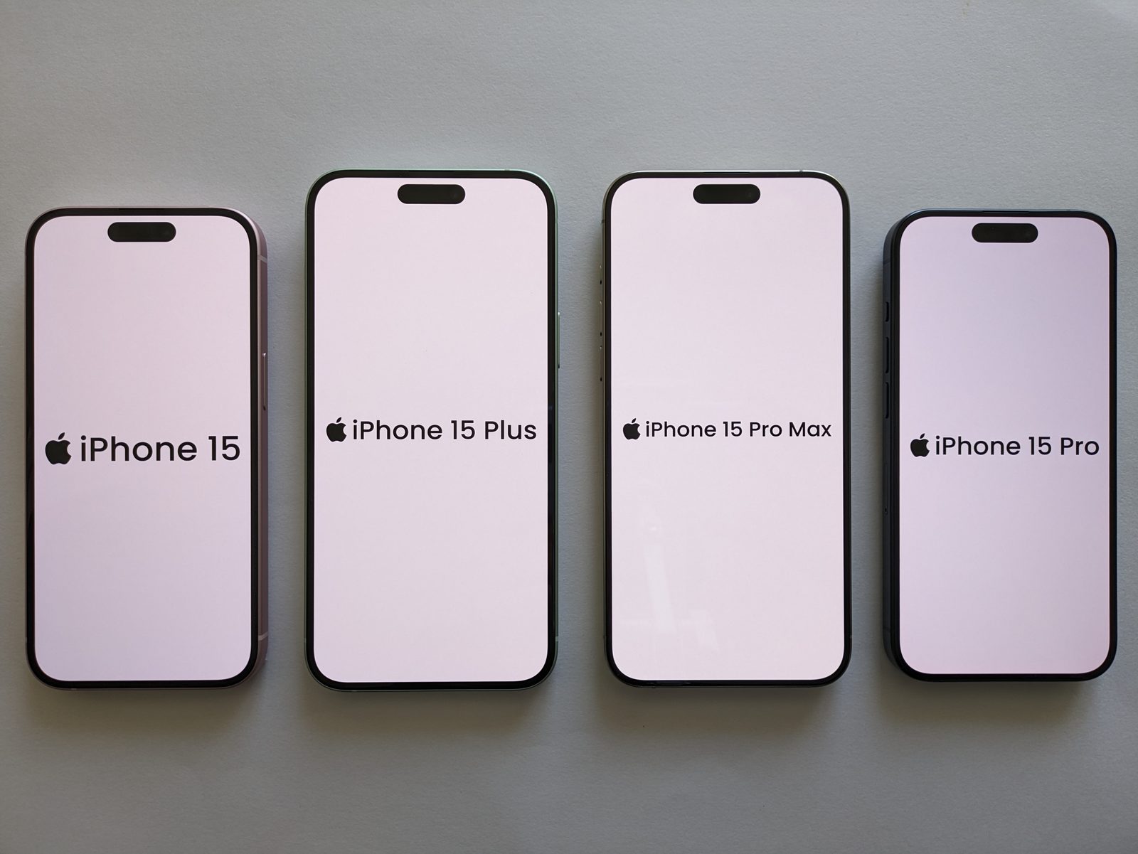 Four Apple iPhone 15 models lined up for a photo — the iPhone 15, iPhone 15 Plus, iPhone 15 Pro Max, and iPhone 15 Pro.